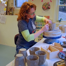 Kristen Kieffer stamping mugs in home studio