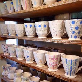 Bisqueware mugs and cups by Kristen Kieffer ready to be glazed